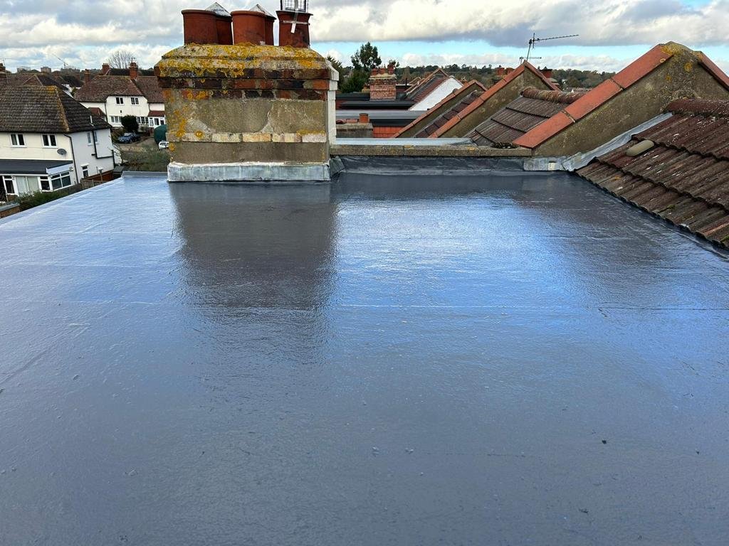 Flat roof covering, with an existing chimney visible at the rear